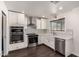 Modern kitchen with stainless steel appliances, white cabinets, and a stylish backsplash at 12241 N 49Th Ave, Glendale, AZ 85304