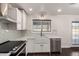 Bright kitchen with a farmhouse sink, stainless steel appliances, and modern finishes at 12241 N 49Th Ave, Glendale, AZ 85304