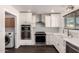 Well-lit kitchen with stainless steel appliances and ample cabinet space at 12241 N 49Th Ave, Glendale, AZ 85304