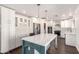 Stylish kitchen featuring an island, wine rack, and stainless steel appliances at 12241 N 49Th Ave, Glendale, AZ 85304