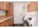 This laundry room boasts cabinets and modern washer and dryer for convenience at 12241 N 49Th Ave, Glendale, AZ 85304