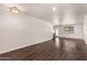 Spacious living room with hardwood floors and modern lighting fixtures at 12241 N 49Th Ave, Glendale, AZ 85304