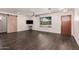 Spacious living room with dark hardwood floors, a sliding barn door, and a ceiling fan at 12241 N 49Th Ave, Glendale, AZ 85304