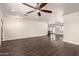 Bright and airy living room featuring hardwood floors and a modern ceiling fan at 12241 N 49Th Ave, Glendale, AZ 85304