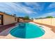 Backyard with an in-ground pool, concrete surround, and gravel at 12241 N 49Th Ave, Glendale, AZ 85304