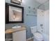 The blue bathroom features a unique sink, toilet, tub, and a framed mirror above the sink at 12613 N 51St Dr, Glendale, AZ 85304