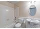 White bathroom features a tub, toilet, and sink, offering a clean and functional space at 12613 N 51St Dr, Glendale, AZ 85304