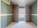 This room features a window, two closets, green walls, white trim, and carpet flooring at 12613 N 51St Dr, Glendale, AZ 85304