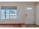 Bright entryway featuring a secure white door, an adjacent window with natural light, and wood-look floors at 12613 N 51St Dr, Glendale, AZ 85304