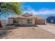 Inviting single-story home with well-maintained desert landscaping, an attached two-car garage, and a quaint front porch at 12613 N 51St Dr, Glendale, AZ 85304