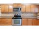 Updated kitchen featuring oak cabinets, granite-style countertops, and stainless steel appliances for modern living at 12613 N 51St Dr, Glendale, AZ 85304