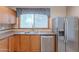 Kitchen includes wood cabinets, stainless steel dishwasher and refrigerator, laminate countertops, and a stainless steel sink at 12613 N 51St Dr, Glendale, AZ 85304