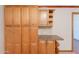 Kitchen pantry with maple cabinetry, granite counters and curved shelving at 12613 N 51St Dr, Glendale, AZ 85304