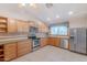 Bright kitchen featuring stainless steel appliances, maple cabinets and granite countertops at 12613 N 51St Dr, Glendale, AZ 85304