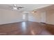Large living room featuring three ceiling fans, hardwood floors, and natural light at 12613 N 51St Dr, Glendale, AZ 85304