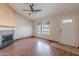 Cozy living area featuring a decorative fireplace, large window, and neutral color scheme at 12613 N 51St Dr, Glendale, AZ 85304