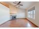 Comfortable living room featuring a decorative fireplace, large window, and wood-look floors at 12613 N 51St Dr, Glendale, AZ 85304