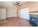 Bright living area showcasing an open layout, decorative fireplace, and wood-look floors at 12613 N 51St Dr, Glendale, AZ 85304