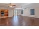 Open-concept living area showcasing hardwood floors and access to the kitchen and backyard at 12613 N 51St Dr, Glendale, AZ 85304
