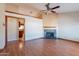 Open concept living area featuring a decorative fireplace and an open doorway to the kitchen at 12613 N 51St Dr, Glendale, AZ 85304