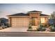 Charming single-story home with desert landscaping, a two-car garage, and stone facade accents at 13573 W Cassia Trl, Peoria, AZ 85383