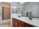 Clean bathroom featuring double vanity sinks and a shower over the bath at 1383 E Prescott Pl, Chandler, AZ 85249