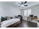 Bright bedroom featuring wood floors, a ceiling fan, and two desk areas for working at 1383 E Prescott Pl, Chandler, AZ 85249