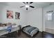 Functional bedroom with ceiling fan, desk area, and plenty of natural light from the window at 1383 E Prescott Pl, Chandler, AZ 85249