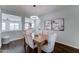 Bright dining room featuring modern chandelier, wood table with cushioned chairs, and hardwood floors at 1383 E Prescott Pl, Chandler, AZ 85249