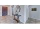 Inviting foyer featuring a rustic console table, decorative mirror, and light tiled floors at 1383 E Prescott Pl, Chandler, AZ 85249