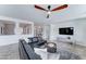 Bright living room featuring a modern fan, stylish black leather sectional, and neutral decor at 1383 E Prescott Pl, Chandler, AZ 85249