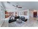 Open-concept living room with tiled floors and dark leather sectional adjacent to the kitchen area at 1383 E Prescott Pl, Chandler, AZ 85249