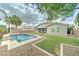 A stunning backyard features a refreshing pool surrounded by lush greenery and a covered patio, ideal for relaxation at 1383 E Prescott Pl, Chandler, AZ 85249