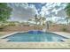 Relax in the backyard oasis, featuring a sparkling pool with a travertine patio and tropical landscaping, perfect for entertaining at 1383 E Prescott Pl, Chandler, AZ 85249