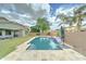 A backyard pool with a travertine patio, a covered patio, a ping pong table, and lush landscaping for outdoor enjoyment at 1383 E Prescott Pl, Chandler, AZ 85249