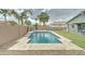 The refreshing backyard pool has travertine patio, a basketball hoop, and lush landscaping, ideal for relaxation and recreation at 1383 E Prescott Pl, Chandler, AZ 85249