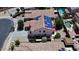 Aerial view of a home with solar panels, a well-maintained yard, and close proximity to neighborhood pool at 15241 W Madison St, Goodyear, AZ 85338