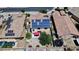 Aerial view of a house with solar panels, backyard with trampoline and pool, showcasing outdoor living at 15241 W Madison St, Goodyear, AZ 85338
