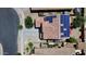 Aerial view of a home with a red tile roof and solar panels, showcasing its sustainable features at 15241 W Madison St, Goodyear, AZ 85338