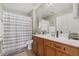 Neutral bathroom featuring a vanity, mirror, a shower with curtain, and toilet at 15241 W Madison St, Goodyear, AZ 85338