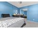 A bedroom features a comfortable bed, a dresser, and a large window at 15241 W Madison St, Goodyear, AZ 85338