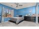 Cozy bedroom with blue walls, a ceiling fan, and an inviting window view at 15241 W Madison St, Goodyear, AZ 85338