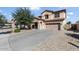 Charming two-story home with a well-manicured front yard and a two car garage at 15241 W Madison St, Goodyear, AZ 85338