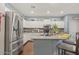 Bright kitchen featuring stainless steel appliances, an island with seating, and stylish countertops at 15241 W Madison St, Goodyear, AZ 85338