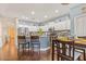 Bright kitchen with white cabinets, a large island with seating, and stainless steel appliances at 15241 W Madison St, Goodyear, AZ 85338