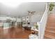 Open-concept living area featuring wood floors, staircase, and a cozy seating arrangement at 15241 W Madison St, Goodyear, AZ 85338