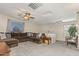 Open living room features a large sectional sofa and ample windows at 15241 W Madison St, Goodyear, AZ 85338