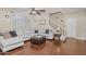 Comfortable living room with wood floors, a large sectional sofa, and modern decor at 15241 W Madison St, Goodyear, AZ 85338