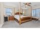 Inviting main bedroom featuring a four-poster bed and plenty of natural light at 15241 W Madison St, Goodyear, AZ 85338