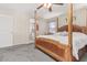 Relaxing main bedroom featuring a four-poster bed and ensuite bathroom at 15241 W Madison St, Goodyear, AZ 85338